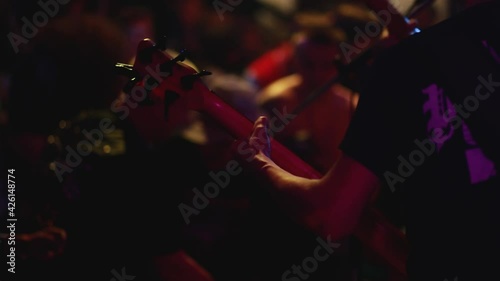 KOVROV, RUSSIA, MAY 25, 2017: The guitarist and bass player play rock powerfully. Rock concert in the club. Party at the nightclub. photo