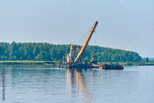 dredger is working to deepen the fairway on the river