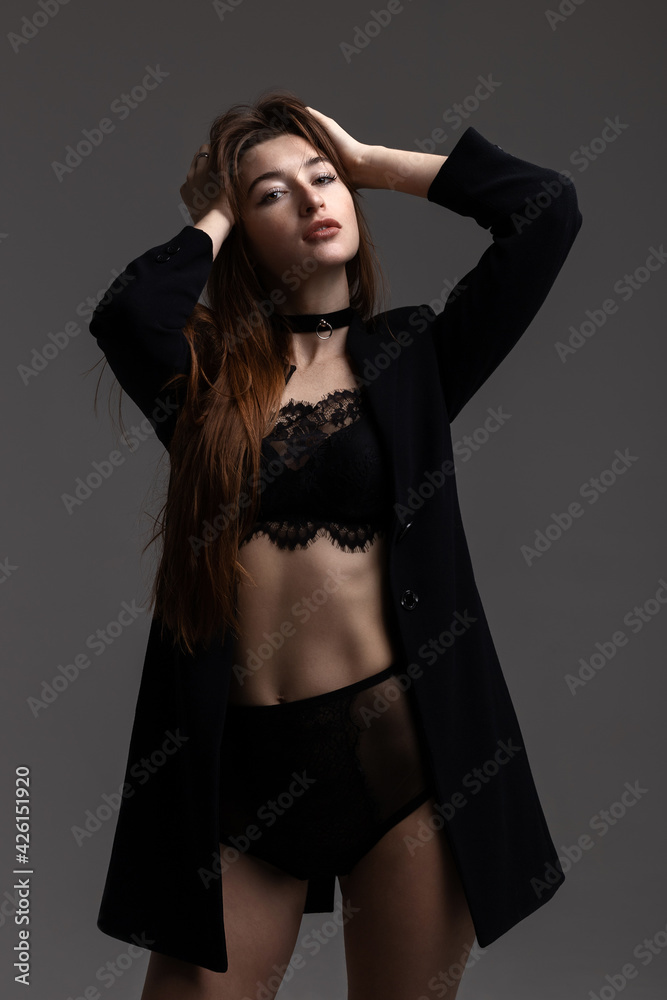 Fototapeta premium Model in total black posing on grey background