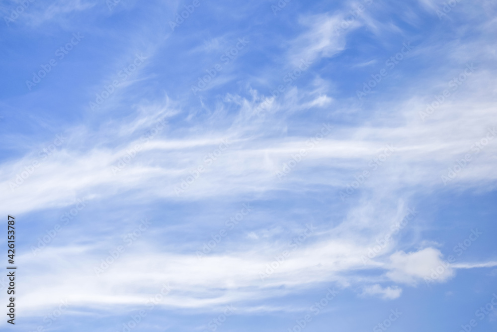 White cirrus rising clouds against blue sky. Atmospheric phenomenon. Natural background. Copy space. Selective focus.