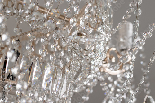 A Chrystal chandelier close-up. Glamour white light background with copy space