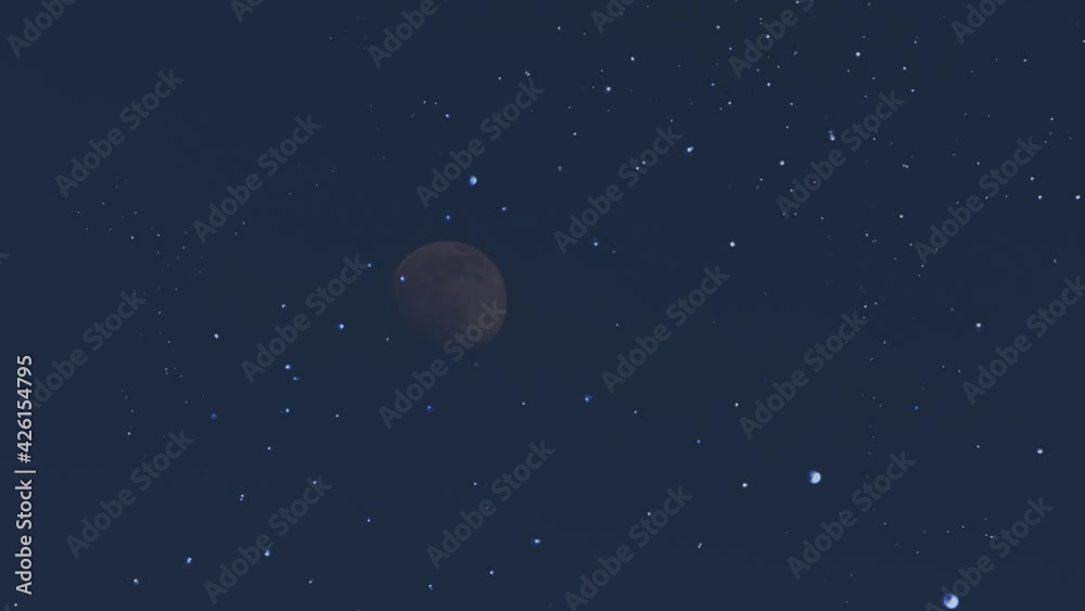 Moon rising through midnight starry skies Moon rising through midnight starry skies