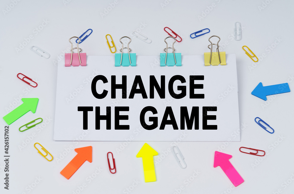 On the table there are paper clips and directional arrows, a sign that says - Change The Game On the table there are paper clips and directional arrows, a sign that says - Change The Game