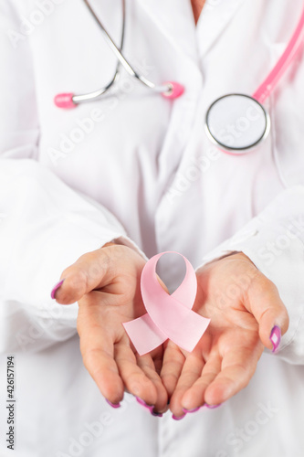 Female doctor holding breast cancer ribbon