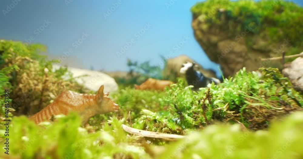 extremely close-up, detailed. figurines of cows in the grass and moss. extremely close-up, detailed. figurines of cows in the grass and moss.