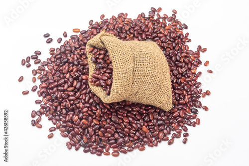 Fresh organic red kidney beans or rajma in a sackcloth bag on white background. photo