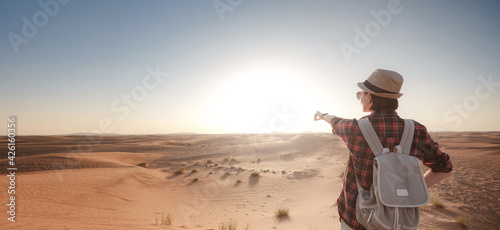attractive asian young woman in plaid shirt in desert