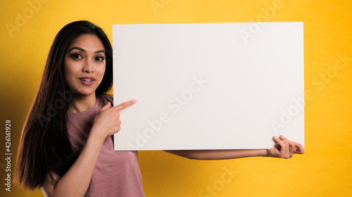 Young pretty woman with a sign dummy - studio photography