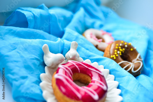 Delicious colorful donuts with different flavors on the background