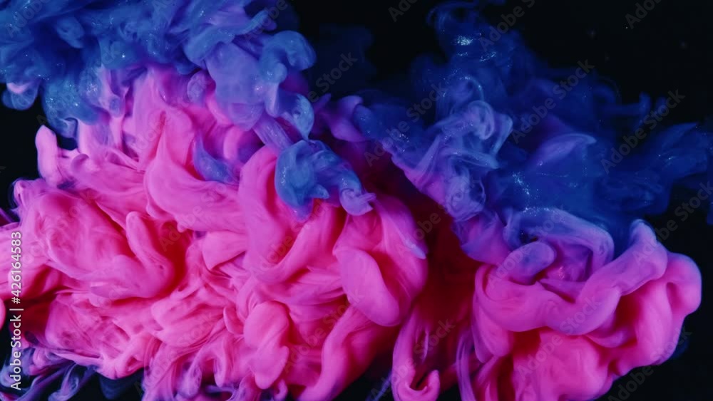 Blue pink acrylic paint spreading in water. Abstract background Blue pink acrylic paint spreading in water. Abstract background