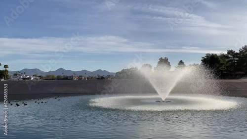 The fountain in McCormick Ranch Lake does double duty, it aerates the water and gives the coots a place to swim, McCormick Ranch, Scottsdale, Arizona. photo