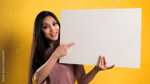 Young beautiful woman holds a sign - studio photography