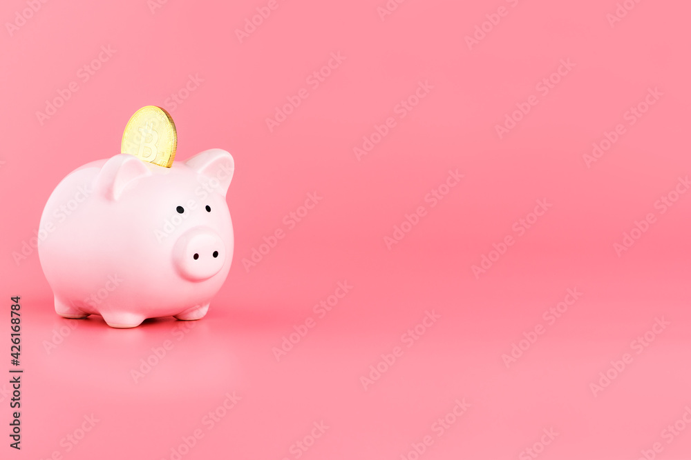 Piggy Bank and bitcoin on a pink background. Bitcoin mining concept Piggy Bank and bitcoin on a pink background. Bitcoin mining concept