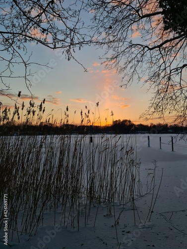 Lightpillar sunset on lake photo