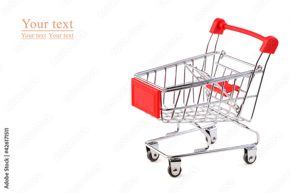 Empty grocery shopping cart. Miniature empty red color shopping cart or trolley isolated on white background. There is some free space for your text or sign.