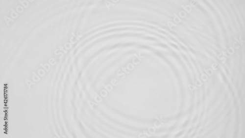 Up close, top view, Slow motion various waves of the water surface hitting the sun's rays, making them sparkle according to different patterns on a gray background video 4K.