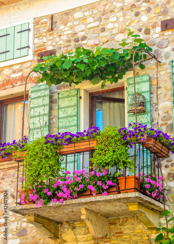 Fototapeta Naklejka Na Ścianę i Meble -  Beautiful window decorated with flowers in Italy.