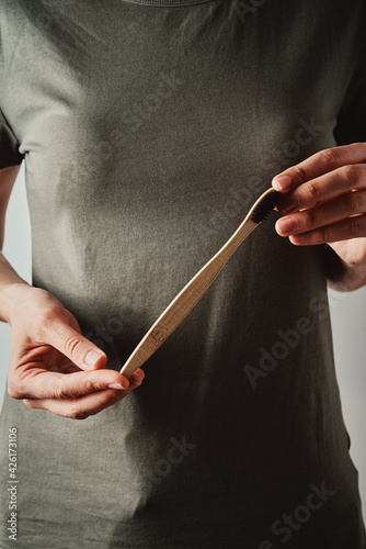 Woman hold bamboo toothbrush, close up