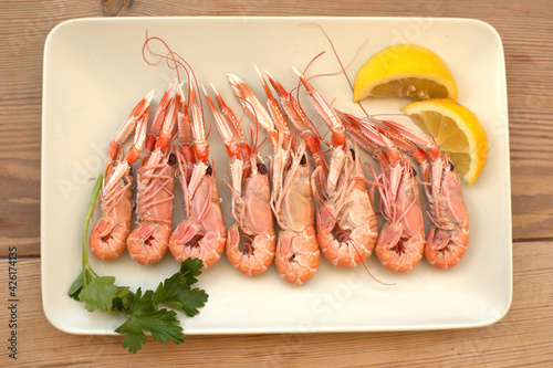 boiled crayfish, with oil and lemon sauce, on a plate, karavides in Greek photo