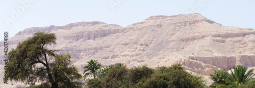 Landscape with mountains and trees in Egypt. Rocky hills. Blue sky