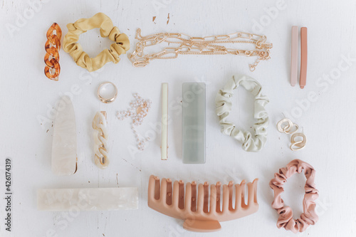 Modern summer accessories layout. Golden jewellery, hair clips, barrettes. Boho colorful accessories photo