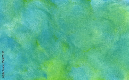 Abstract bright banner made by hand with acrylic and watercolors. the background is drawn with chaotic brush movements. Blue and green are mixed with each other.