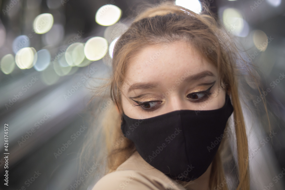 Girl wearing a protective mask amid Covid-19 pandemics in the Warsaw's subway Girl wearing a protective mask amid Covid-19 pandemics in the Warsaw's subway