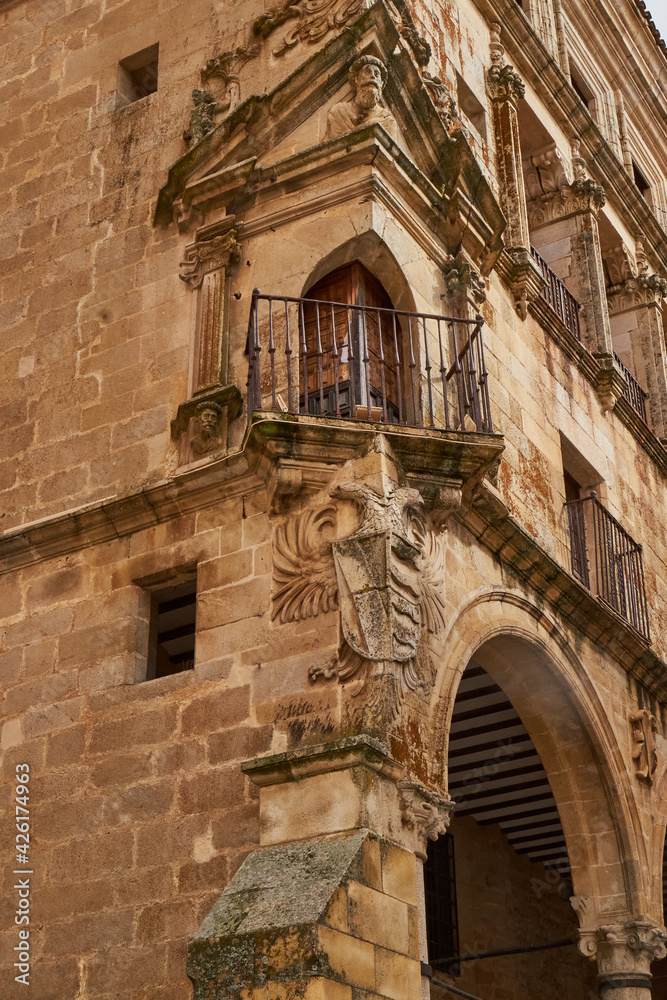 Shield and corner balcony in the palace of the Dukes of San Carlos in the Plaza Mayor of Trujillo (Cáceres)