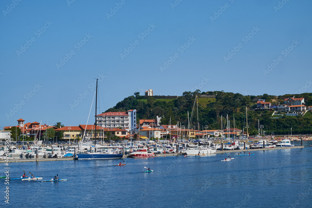 View of the Ribadesella estuary (Ribeseya) with athletes practicing canoeing. Town in eastern Asturias.