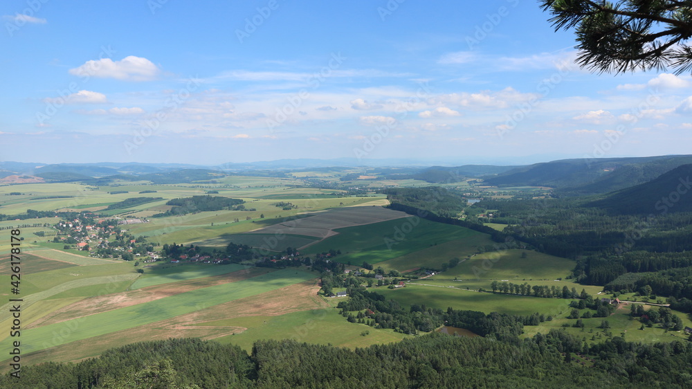A view to the landscape with fields and forests from the lookout place Koruna near Broumov, Czech republic