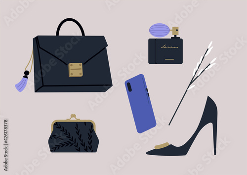 A set of premium fashion accessories in black colors, a handbag with a tassel key chain, a bottle of perfume with a pump, a silk purse with a clasp, a mobile phone, and a pair of elegant high heels
