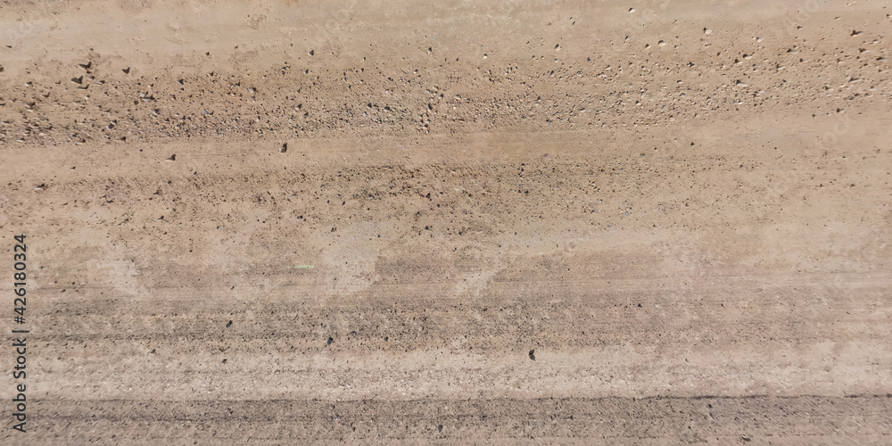 view from above on car tire tracks on texture of gravel road view from above on car tire tracks on texture of gravel road