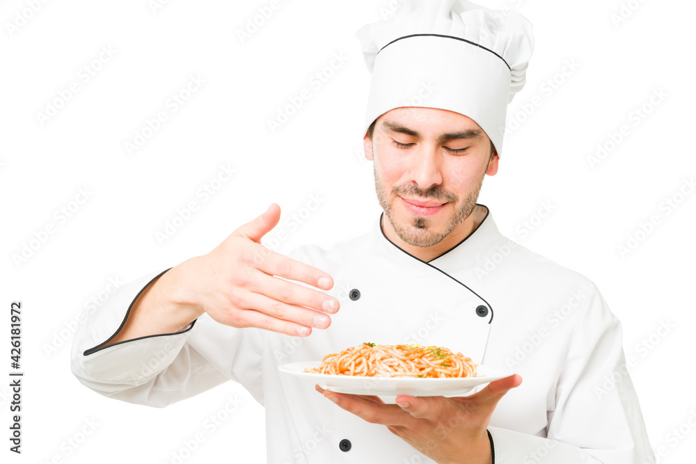 Professional chef holding a plate of spaghetti Professional chef holding a plate of spaghetti