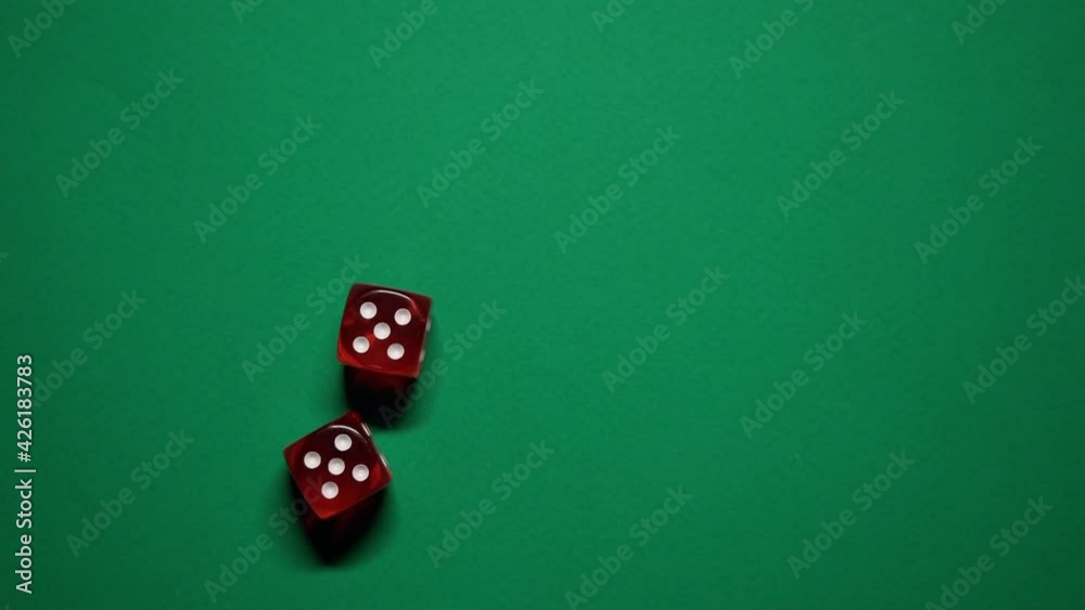 Red dice falling on green table. The Numbers 5 and 5 Appear on the Dice. Red dice falling on green table. The Numbers 5 and 5 Appear on the Dice.