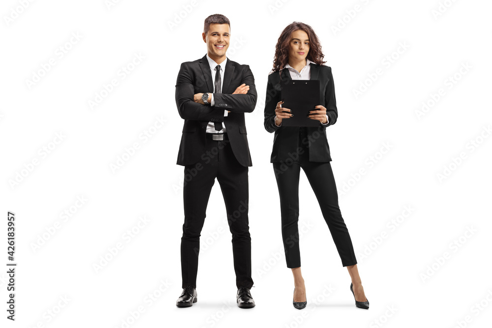 Young man and woman in formal clothes posing and looking at camera Young man and woman in formal clothes posing and looking at camera