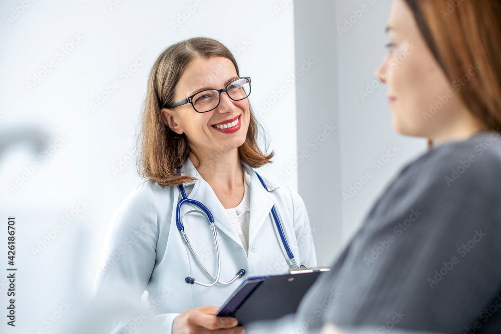 Female doctor therapist talking with a patient in a medical room. Women's consultation with a gynecologist. Female doctor therapist talking with a patient in a medical room. Women's consultation with a gynecologist.