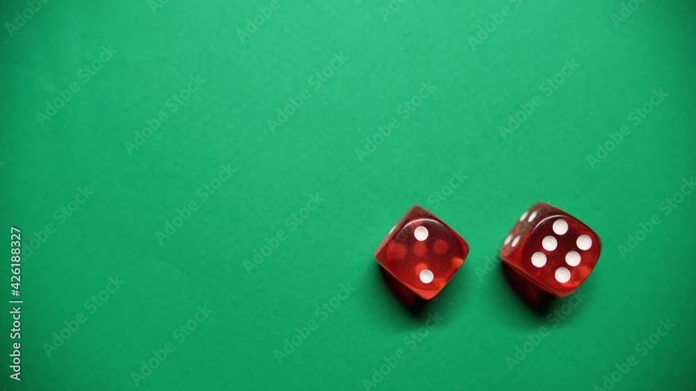 Red dice falling on green table. The Numbers 5 and 3 Appear on the Dice. Red dice falling on green table. The Numbers 5 and 3 Appear on the Dice.