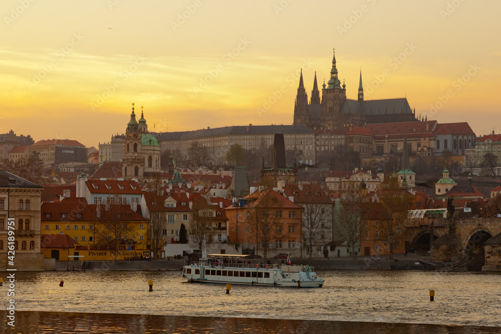 Obraz premium View over Vltava river or Moldau in Prague towards Prague castle and cathedral.