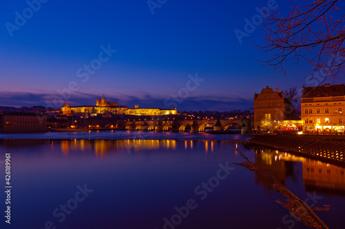 Prague at night along the river with Cathedral and Castle lit up  Czech Republic 