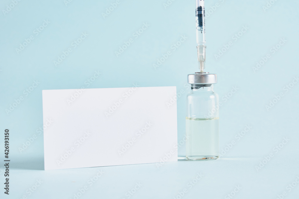 mock up white plate, insulin syringe and medicine vial for injection on blue background copy space, vaccination concept mock up white plate, insulin syringe and medicine vial for injection on blue background copy space, vaccination concept