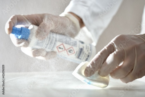Fotografie Laboratory agent nurse doctor cleaning desinfecting surface with desinfection re