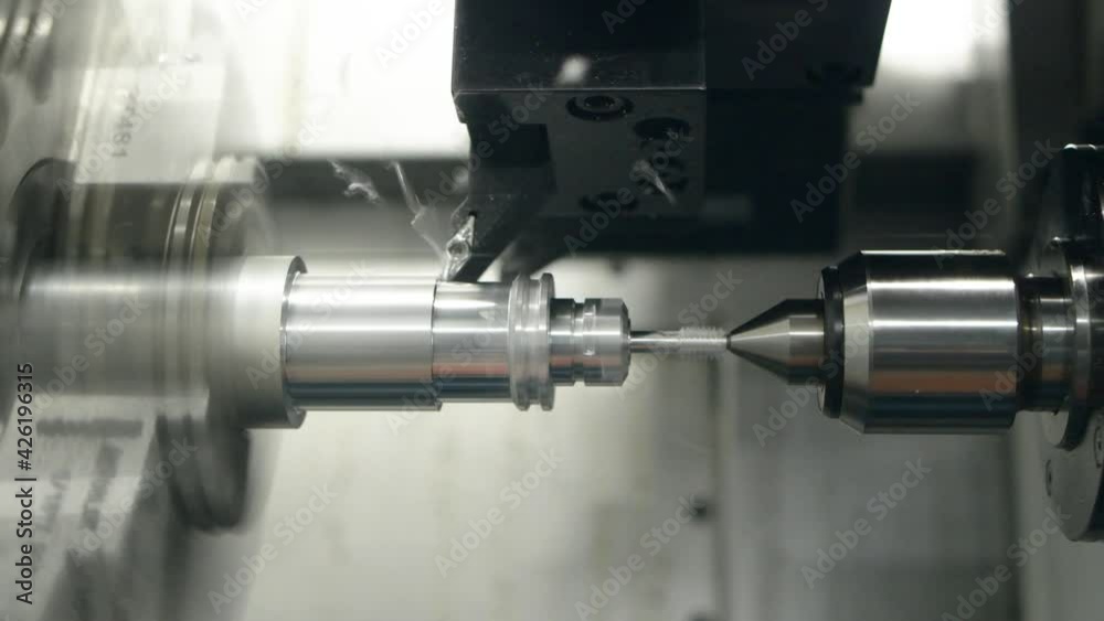 cnc machine at work. cutting tool processing steel metal detail on turning cnc lathe machine in workshop