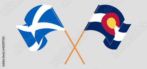 Crossed and waving flags of Scotland and The State of Colorado