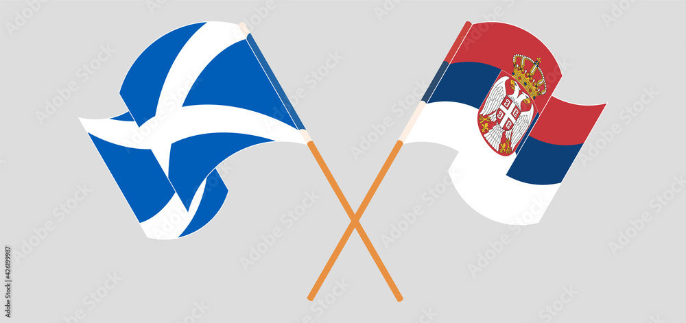 Crossed and waving flags of Scotland and Serbia