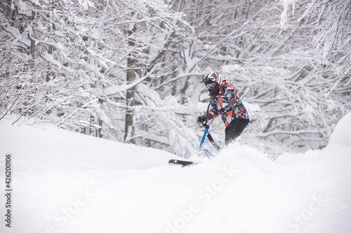 Riding downhill with a snowscoot (snowbike)