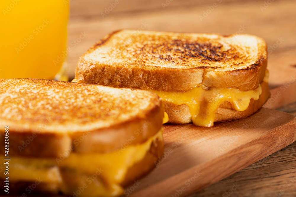Grilled ham and cheese. Sandwich with cheese and ham on grill.