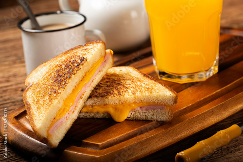 Grilled ham and cheese. Sandwich with cheese and ham on grill. photo