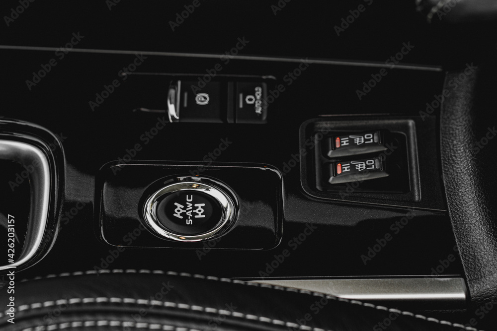 Fototapeta premium Seat heating and Super All Wheel controller buttons close up view. Car interior. Four-wheel drive button. S-AWC.
