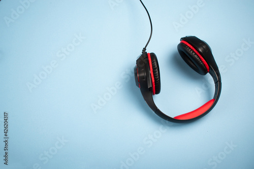 Headphones on a blue surface with acopy space photo