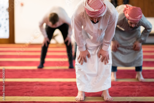 group of muslim people praying namaz in mosque.